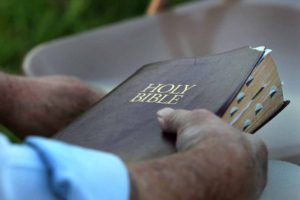 man-hands-holding-bible